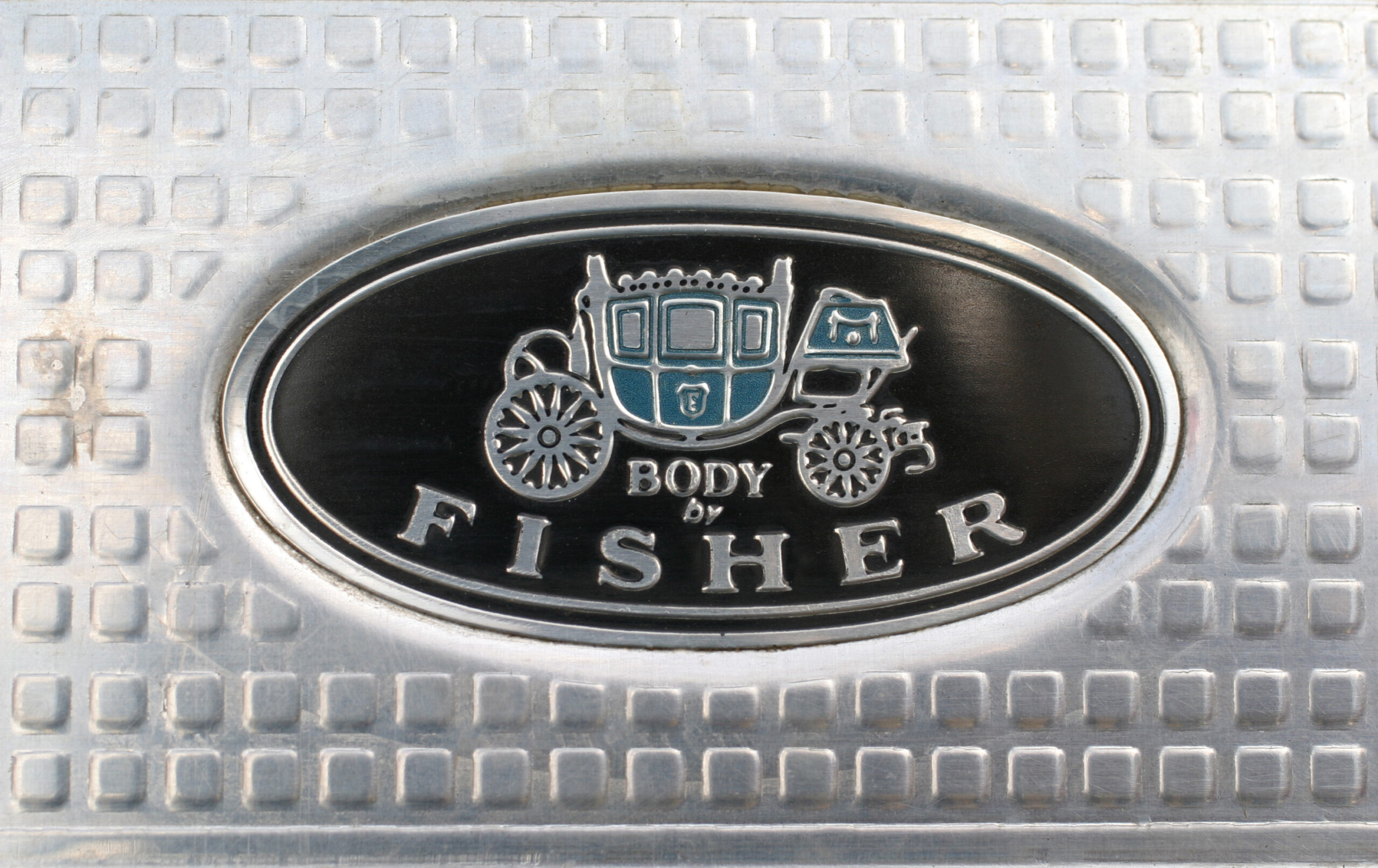 Body by Fisher oval emblem on door sill. (©Photo by Segura)