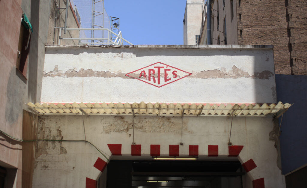 Artes logo above factory garage entrance. (©Photo by Segura)