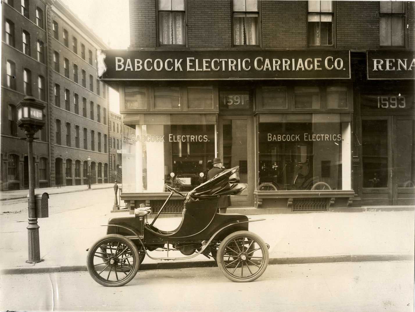 Babcock electric car parked in front of the Babcock Electric Carriage Co. dealership in 1908. (source: National Automotive History Collection, Detroit Public Library.)