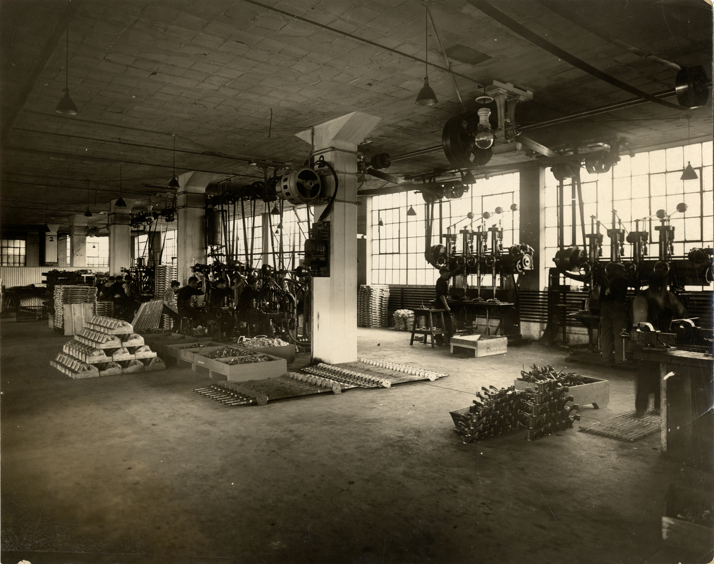 Workers operating machinery to manufacture parts for Detroit Electric cars at the Anderson Electric Car Company factory in 1912. (source: National Automotive History Collection, Detroit Public Library.)