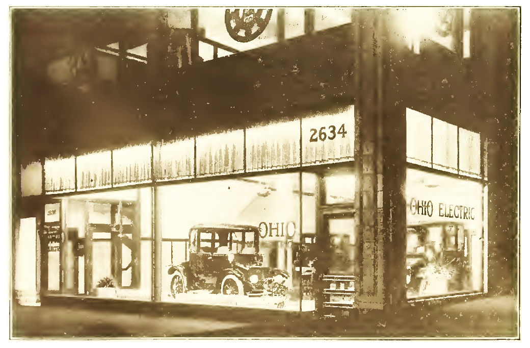 1916 New Ohio Quarters. Realizing the value of an attractive show room and incidentally its overhead expense, E.C. Scheffler, the new manager of the Chicago Branch of the Ohio Electric Car Company, has his new premises, 2634 Michigan Avenue, working for him day and night. The brilliantly lighted interior shows off the new Ohio car to splendid advantage at night and makes an attractive picture bound to arrest one's attention even among the well lighted show rooms of Motor Row. The new location has the advantage of two windows exposures. The salesrooms are large and airy, painted in a cheerful cream tint. The service department in the rear is large and commodious.